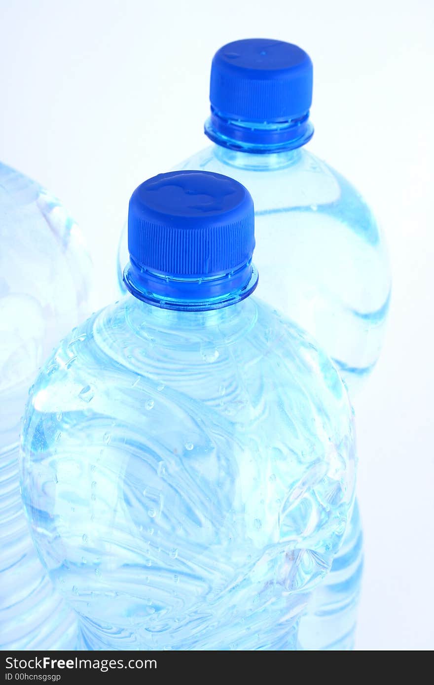 Mineral water pouring from a blue bottle