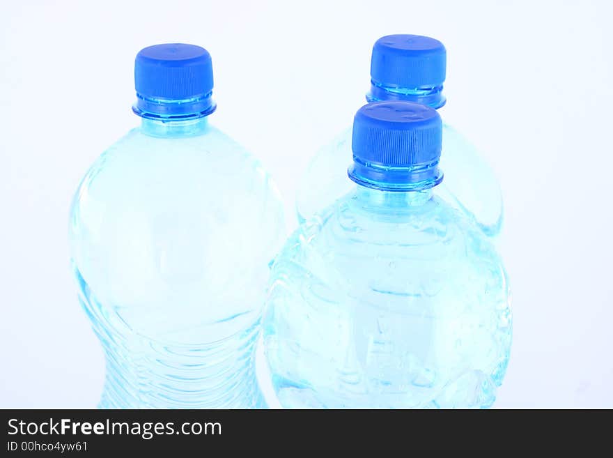 Mineral water pouring from a blue bottle