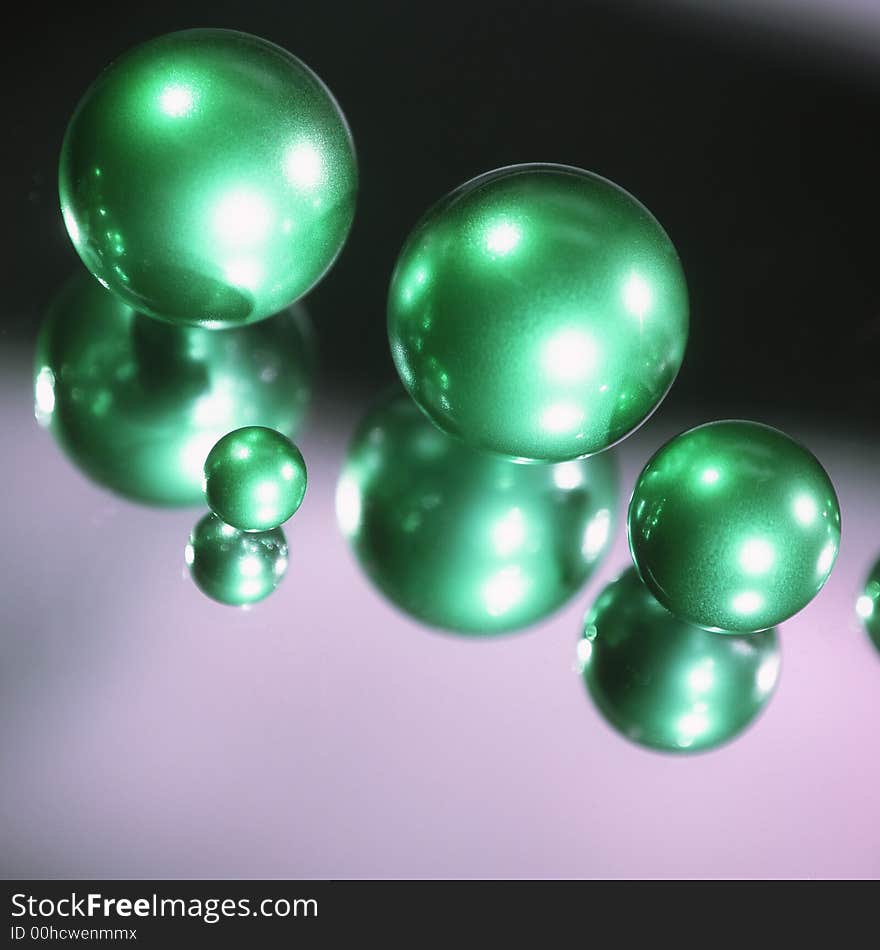 Green spheres on a black background