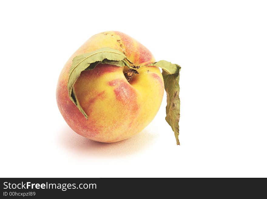 Ripe fresh peach with leaves