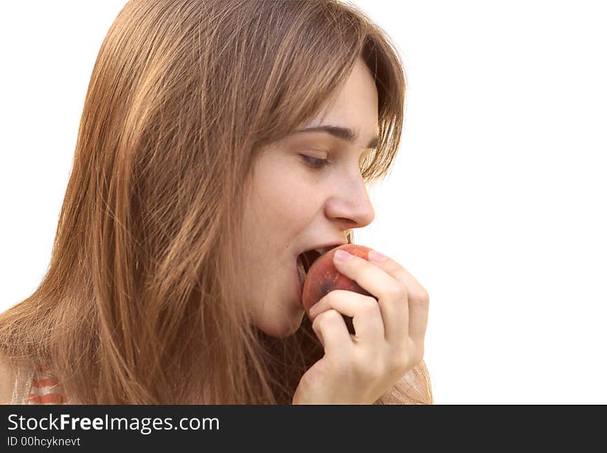 Young girl eating big ripe juicy peach. Young girl eating big ripe juicy peach