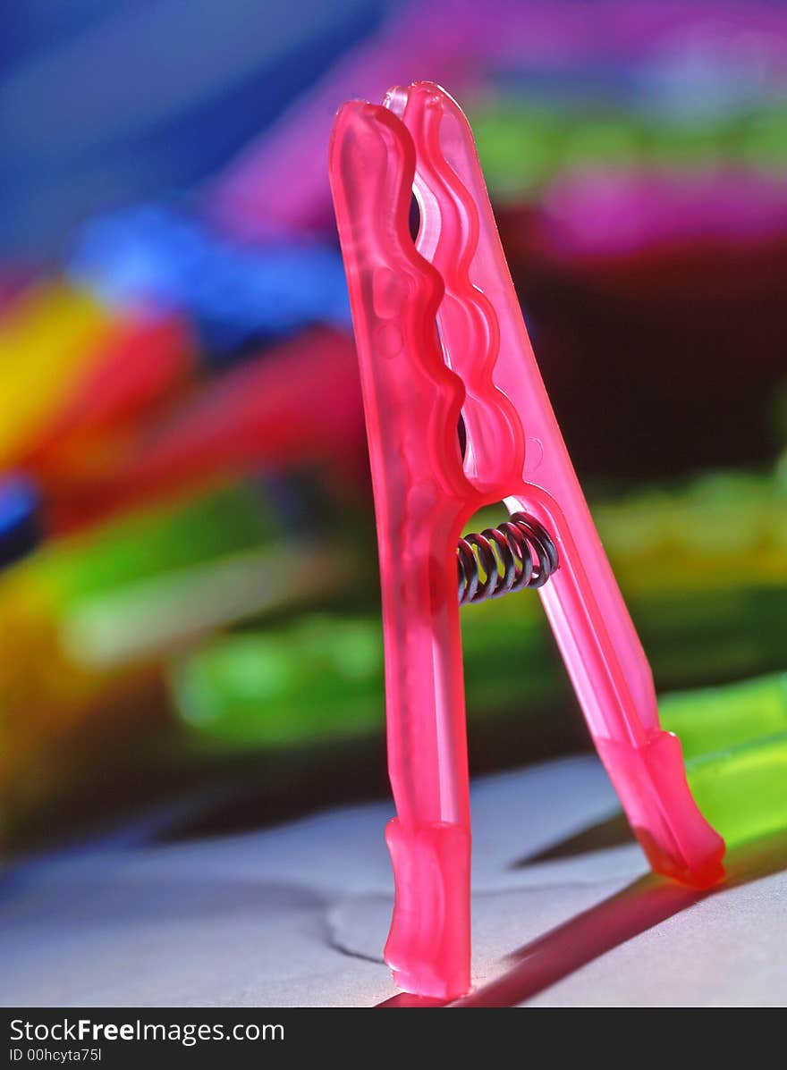 Clothespin of pink color on a blue background