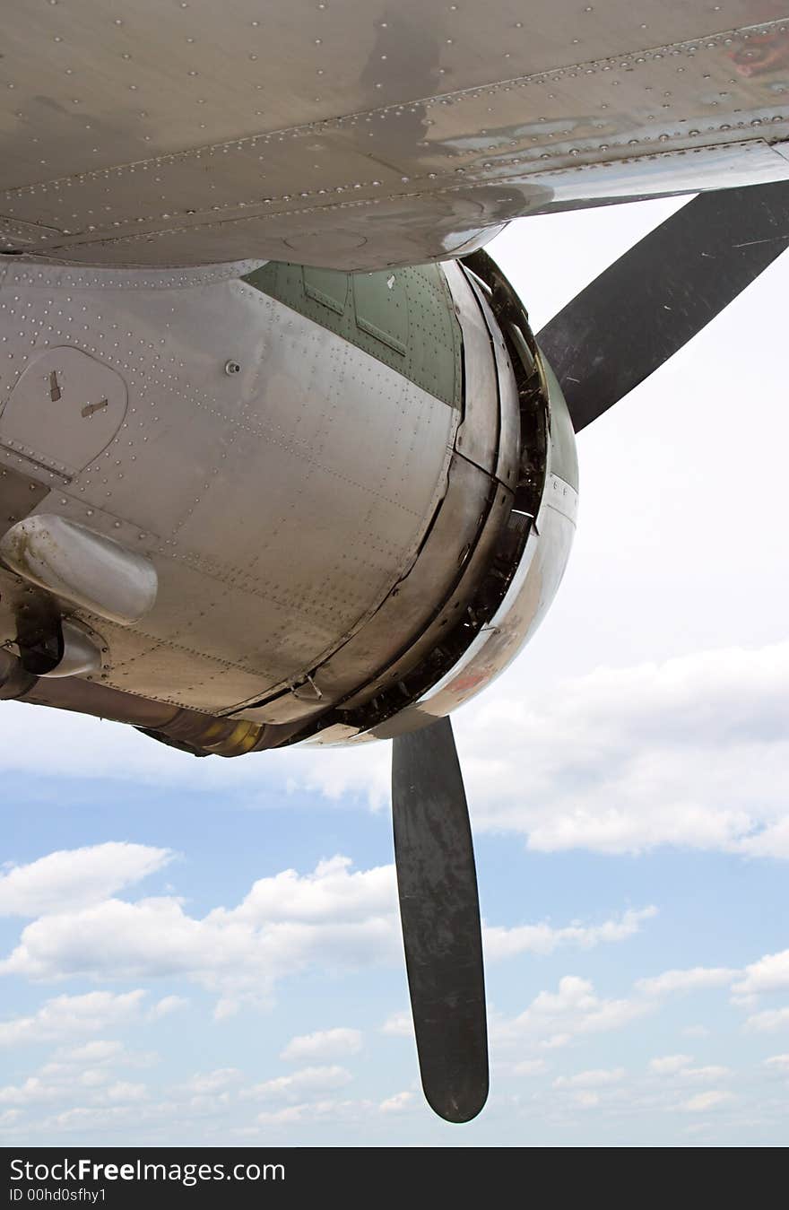 Belwo an airplane wing looking at the engine with the sky as the background. Belwo an airplane wing looking at the engine with the sky as the background.