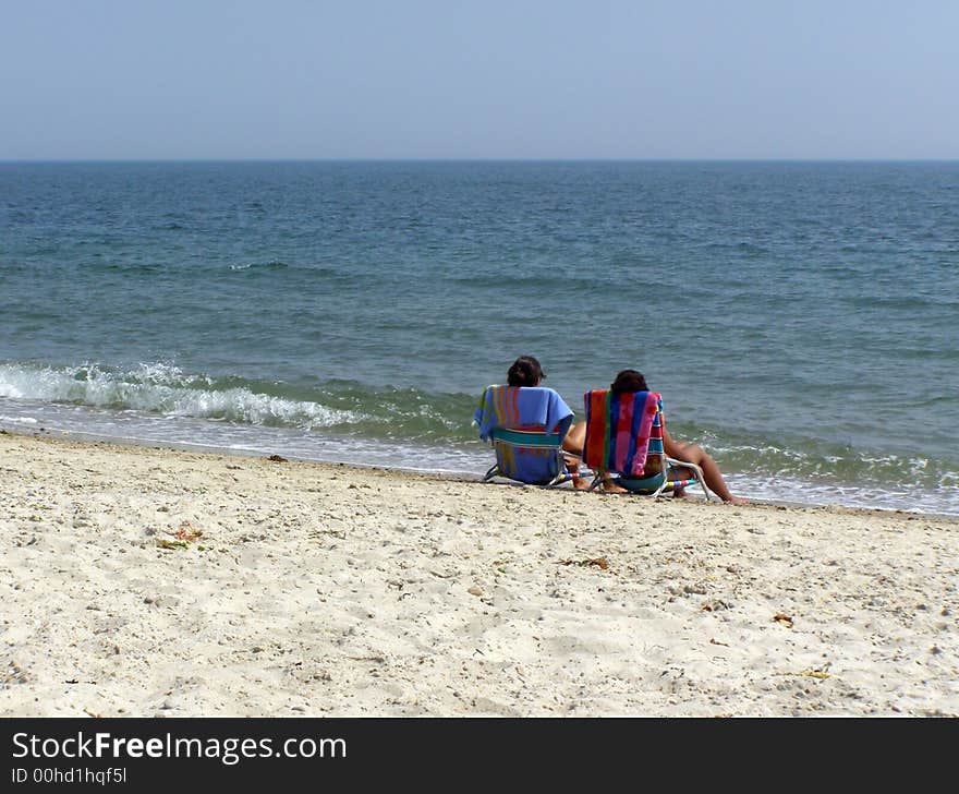 Two women getting a suntan at the beach. Two women getting a suntan at the beach