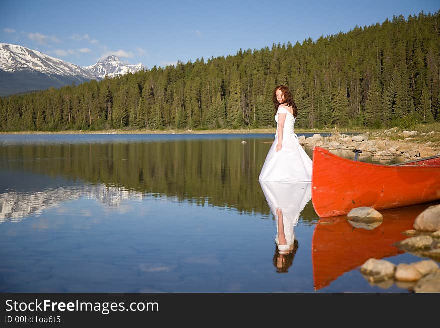 A newly married bride enjoys the waters of Patricia Lake in Jasper National Park, Canada. A newly married bride enjoys the waters of Patricia Lake in Jasper National Park, Canada.