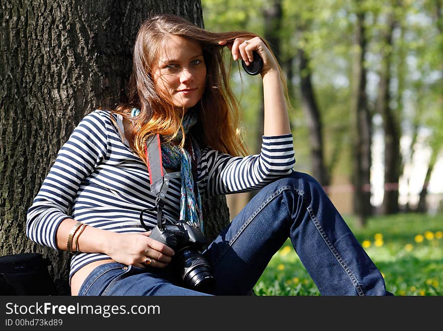 The girl-photographer in spring park. The girl-photographer in spring park