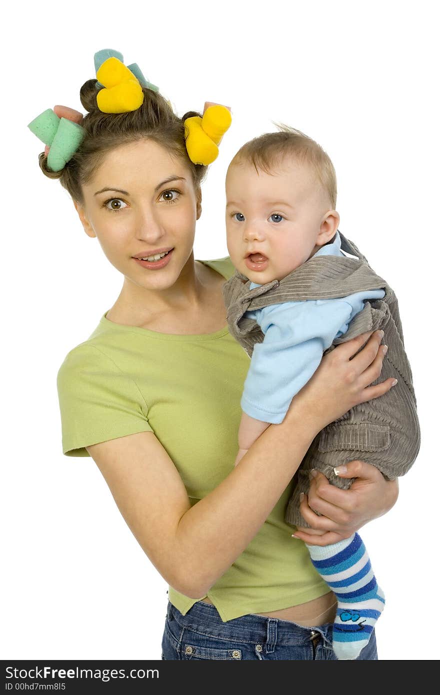 Young, beautiful woman with baby on hands. Smiling and looking at camera. Baby looks bored. White background. Young, beautiful woman with baby on hands. Smiling and looking at camera. Baby looks bored. White background