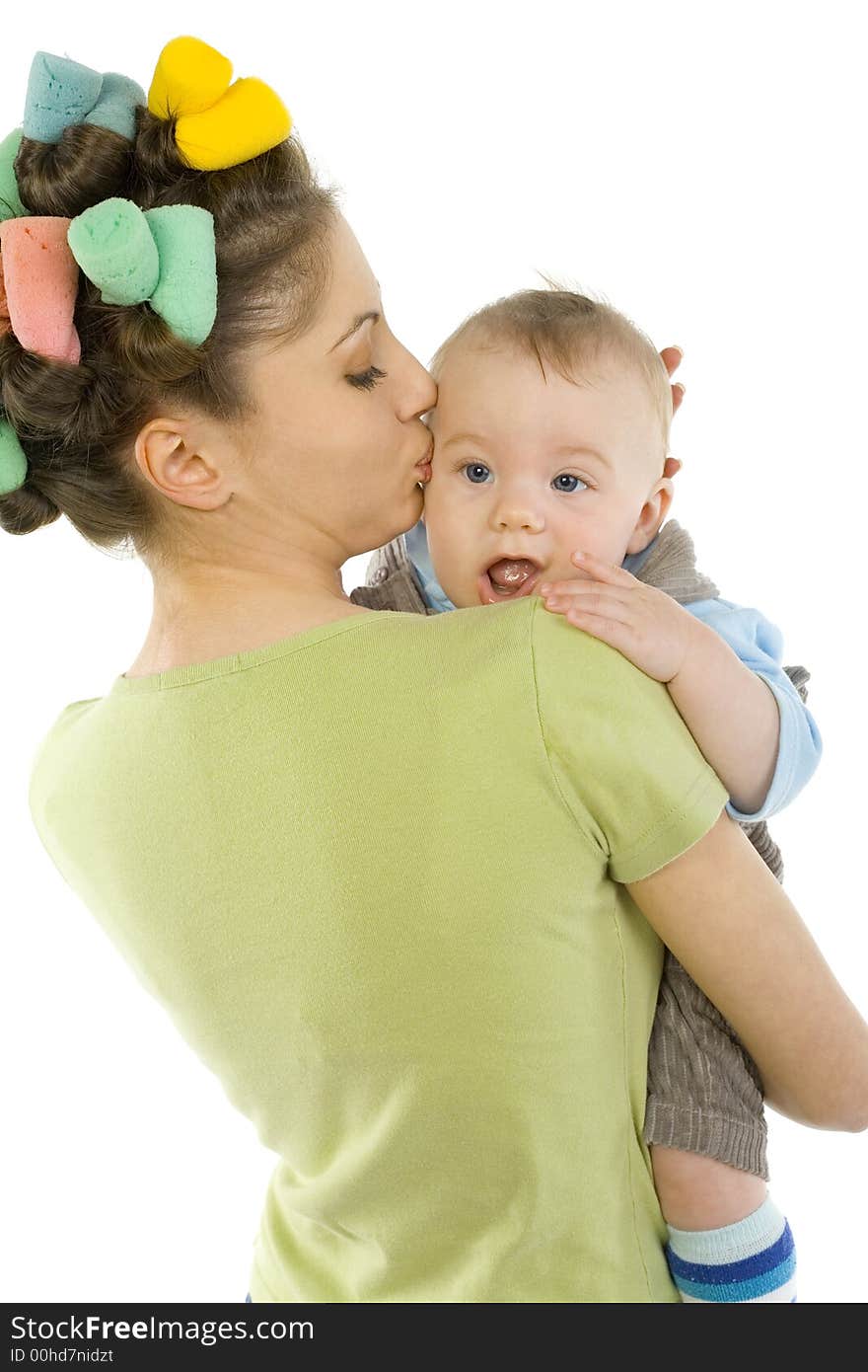 Young, beautiful woman with baby on hands. Hugging baby and kissing. Looking at camera, white background. Young, beautiful woman with baby on hands. Hugging baby and kissing. Looking at camera, white background