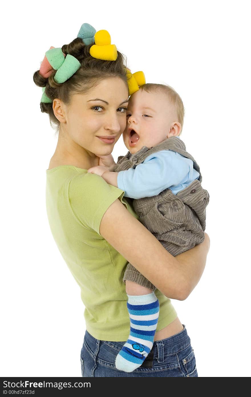 Young, beautiful woman with baby on hands. Hugging baby and smiling. Baby is yawn. Looking at camera, white background. Young, beautiful woman with baby on hands. Hugging baby and smiling. Baby is yawn. Looking at camera, white background