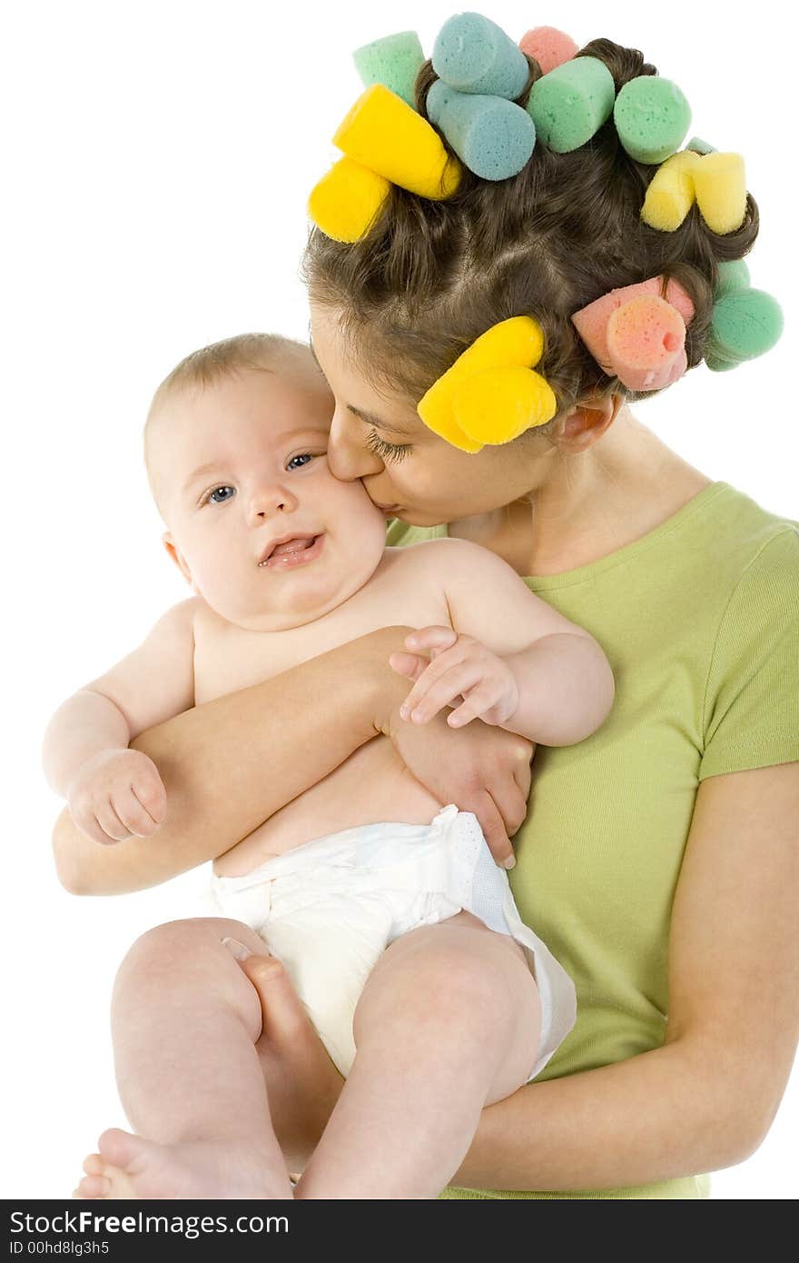 Young, beautiful woman with baby on hands. Hugging baby and kissing. baby is looking at camera. White background, front view. Young, beautiful woman with baby on hands. Hugging baby and kissing. baby is looking at camera. White background, front view