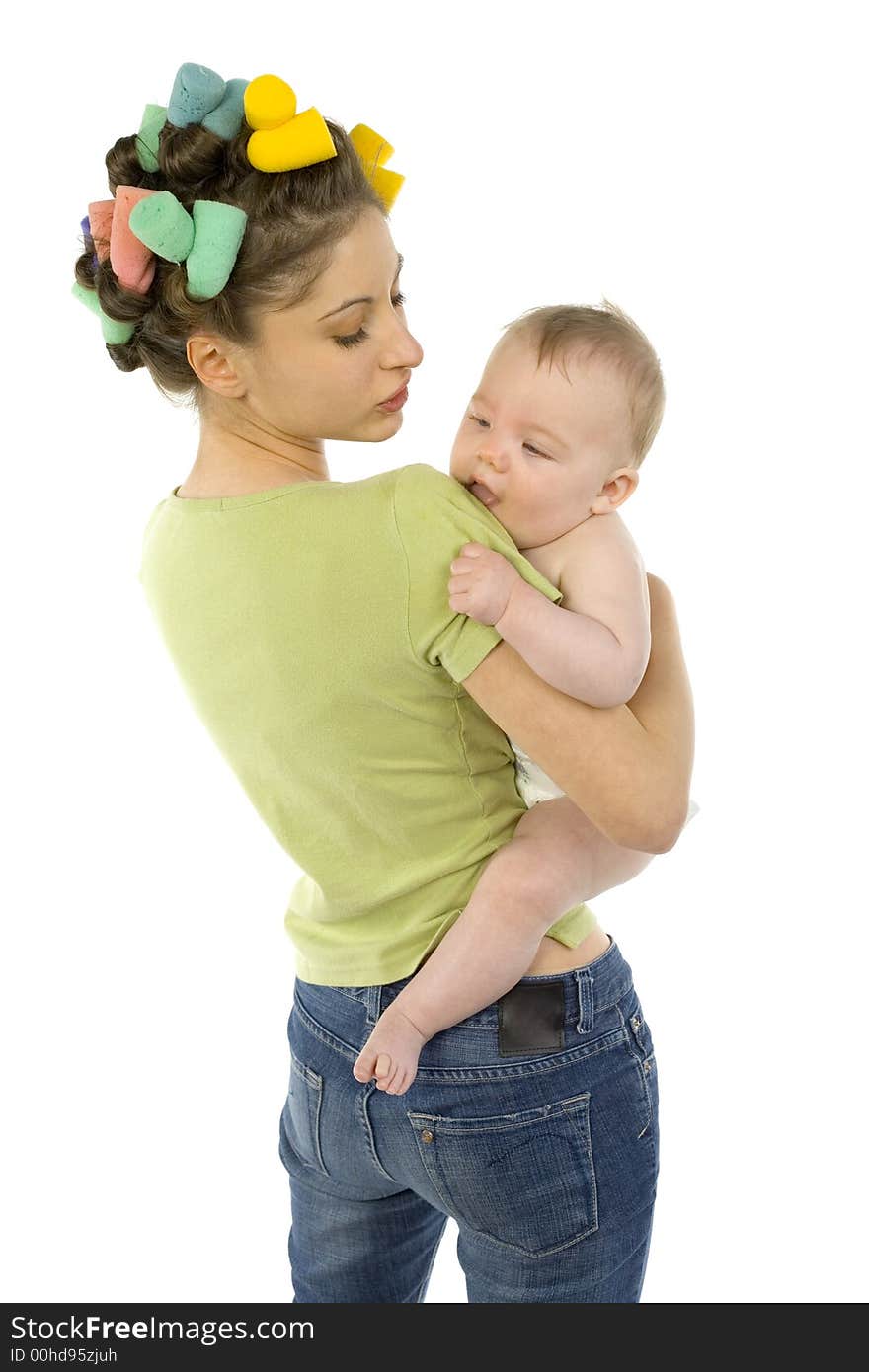 Young, beautiful woman with baby on hands. Baby is biting mother's arm. Mother is looking at baby. White background. Young, beautiful woman with baby on hands. Baby is biting mother's arm. Mother is looking at baby. White background