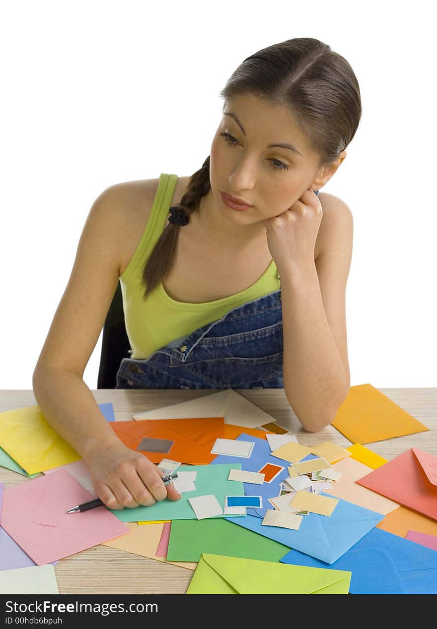 Young, beautifu, sadl woman sitting and writing a letter. Thinking of something, front view. White background. Young, beautifu, sadl woman sitting and writing a letter. Thinking of something, front view. White background