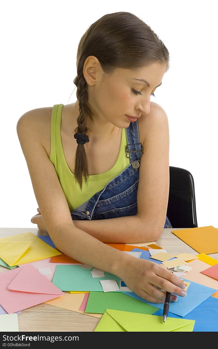 Young, beautiful, sad woman sitting and writing a letter. Thinking of something, front view. White background. Young, beautiful, sad woman sitting and writing a letter. Thinking of something, front view. White background