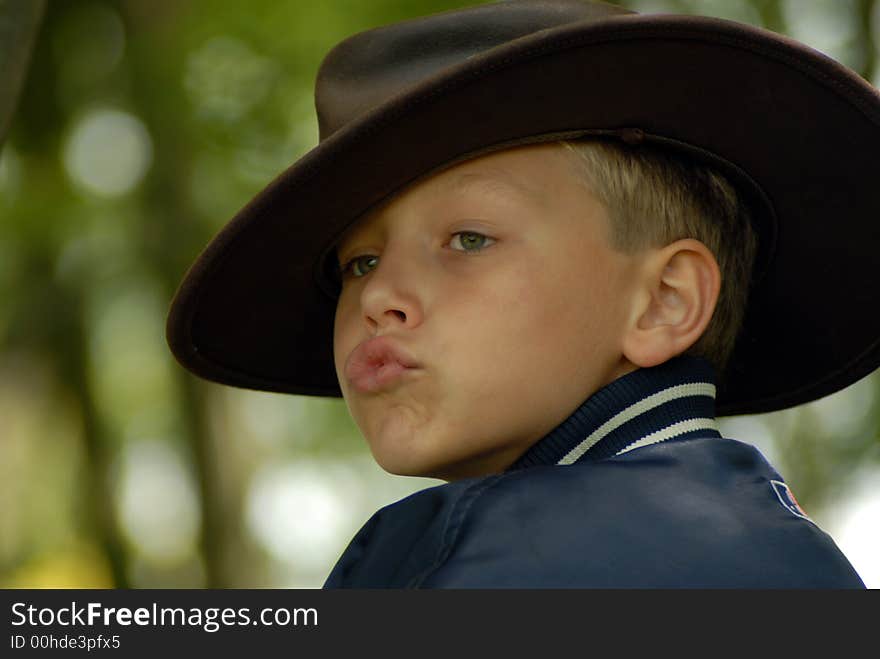 Young boy with pursed lips looks thoughfully in to distance. Young boy with pursed lips looks thoughfully in to distance.