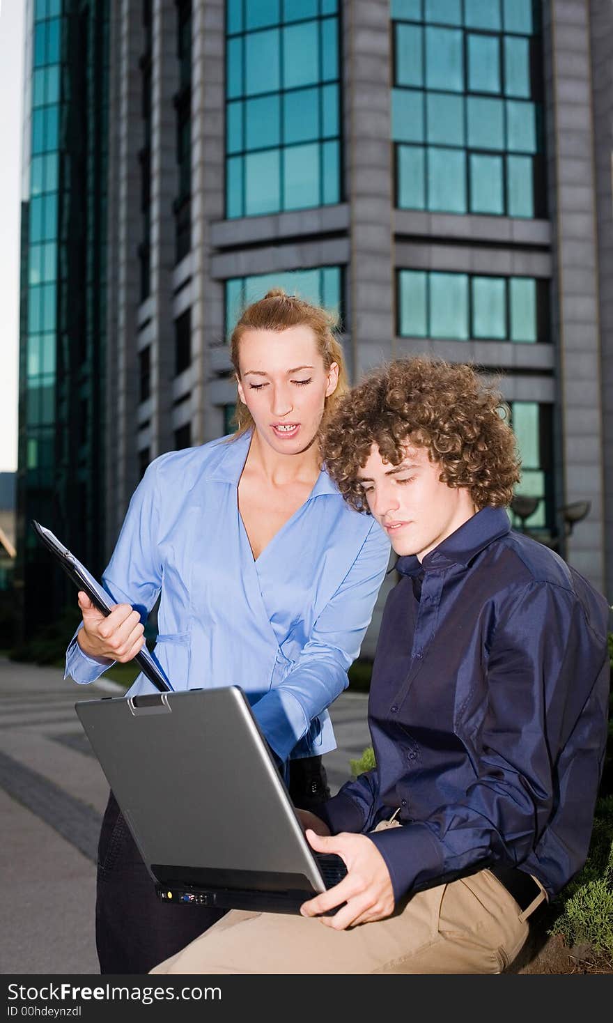 Two young businessmen discussing together. Two young businessmen discussing together