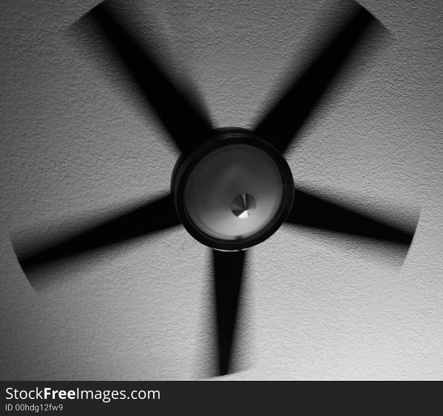 A black and white photo of a modern-style fan. The motion of the fan has blurred the image somewhat. A black and white photo of a modern-style fan. The motion of the fan has blurred the image somewhat.