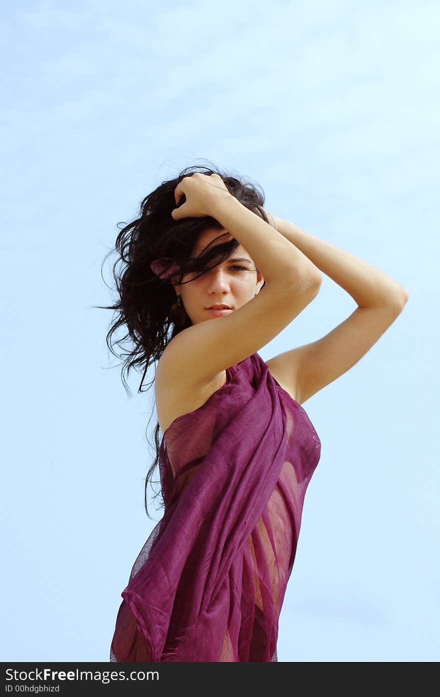 Young tropical girl portrait on blue sky background. Young tropical girl portrait on blue sky background