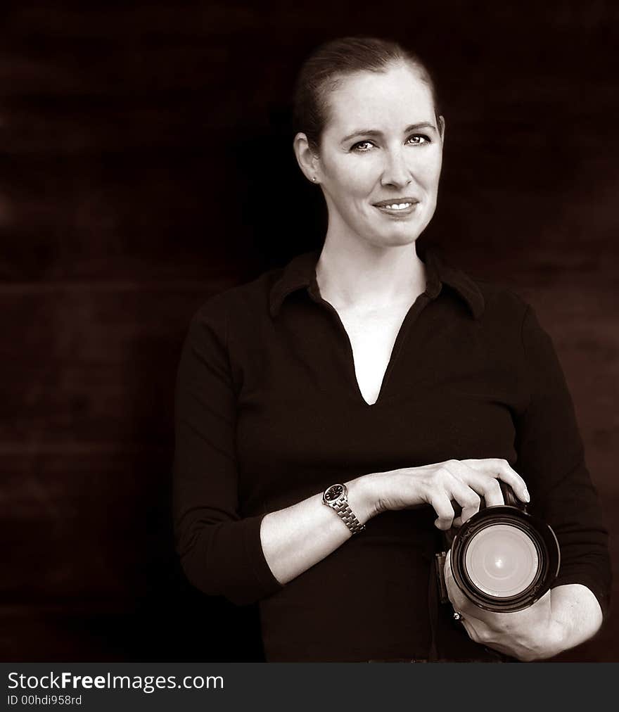 Very Nice image of a beautiful woman posing with a camera. Very Nice image of a beautiful woman posing with a camera