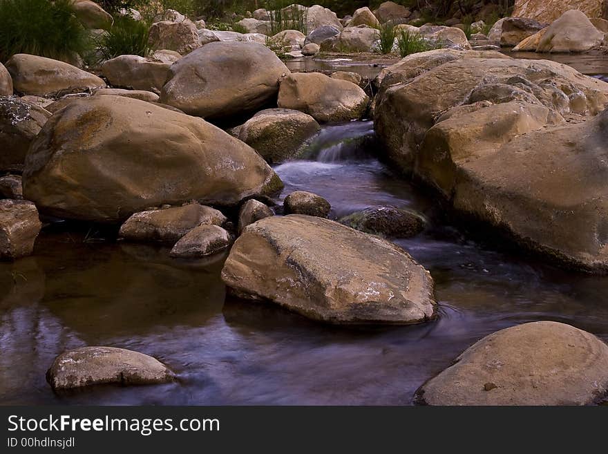 Flowing stream surrounded by beautiful boulders