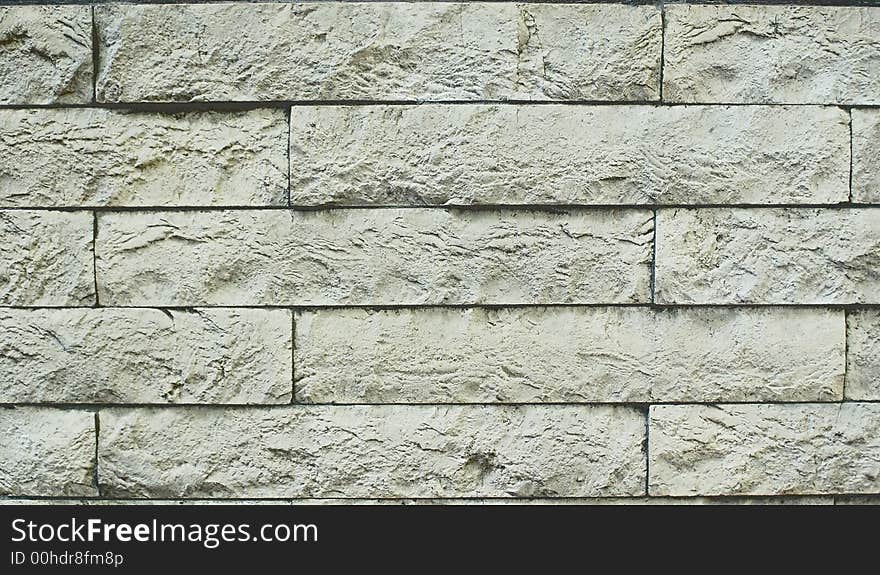 A structure of a wall from an artificial grey stone; the good background creating sensation of hardness and reliability. A structure of a wall from an artificial grey stone; the good background creating sensation of hardness and reliability.