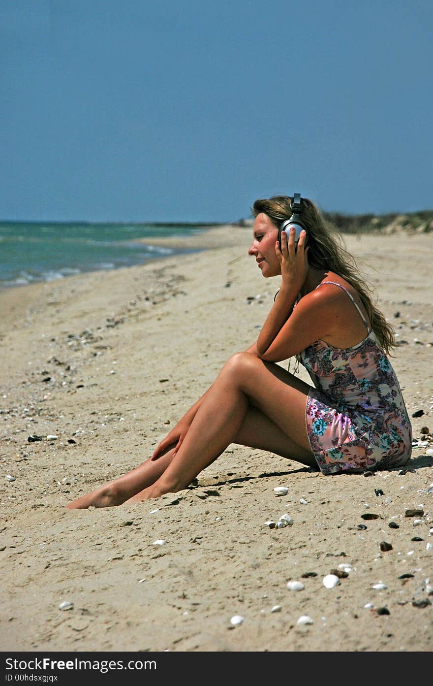 A lovely girl with the headphones listening to music. A lovely girl with the headphones listening to music