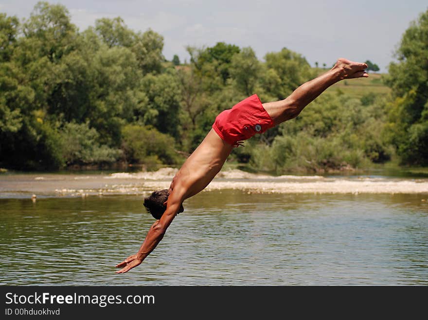 Man jumping in green river. Man jumping in green river