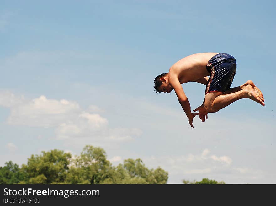 Man jumping in green river. Man jumping in green river