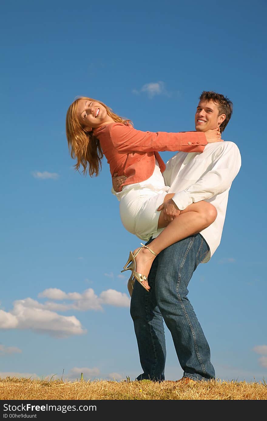 Man holds young girl at his hands