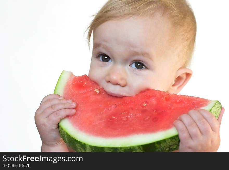 Image of cute toddler eating a big piece of watermelon. Image of cute toddler eating a big piece of watermelon