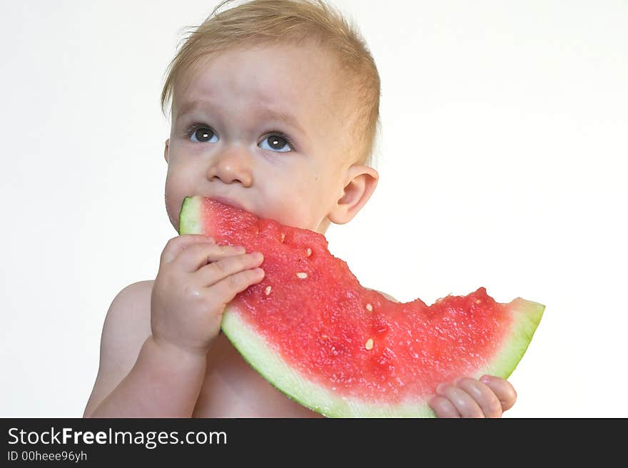 Image of cute toddler eating a big piece of watermelon. Image of cute toddler eating a big piece of watermelon