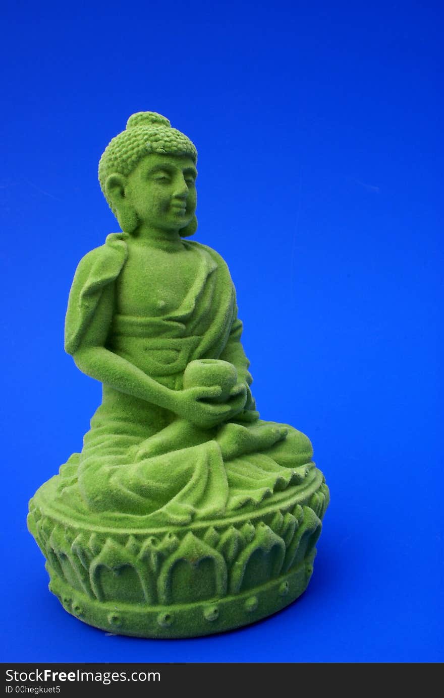 Green buddha against blue background. Green buddha against blue background.