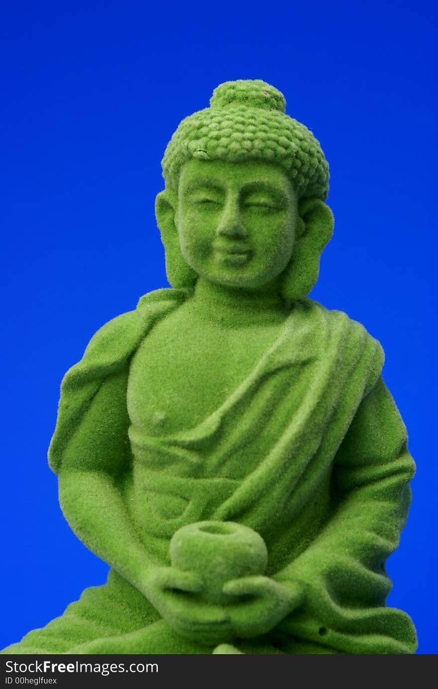 Green buddha against blue background. Green buddha against blue background.