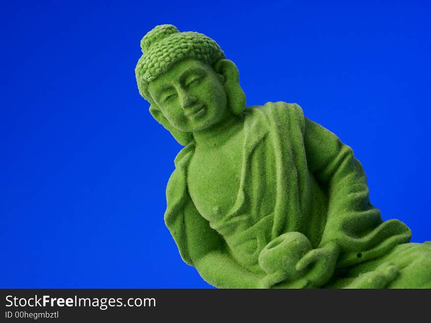 Green buddha against blue background. Green buddha against blue background.