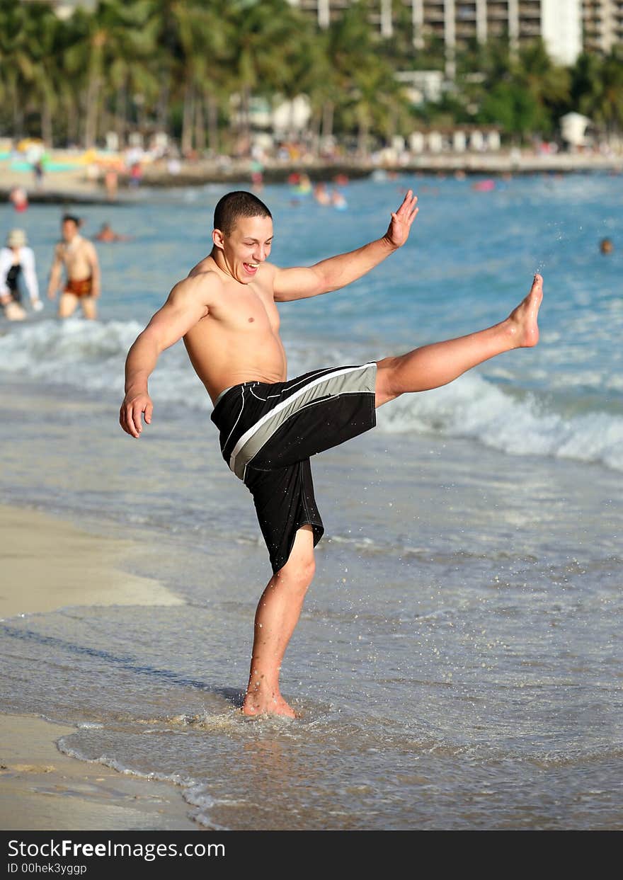 Happy teen boy having fun on the beach