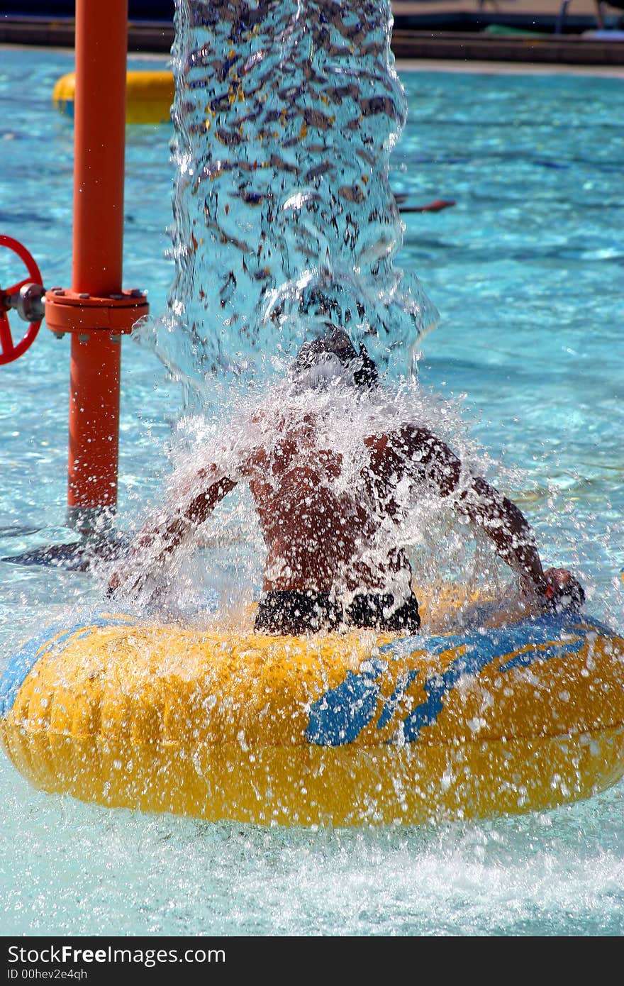 Little boy under waterfall at the pool. Little boy under waterfall at the pool