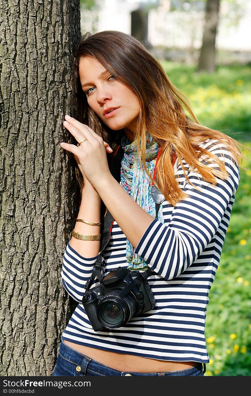 The girl-photographer in spring park. The girl-photographer in spring park