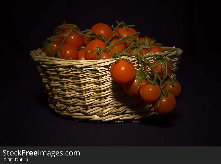 A shoot of pachino's tomato, typical sicily tomato in a basket. A shoot of pachino's tomato, typical sicily tomato in a basket