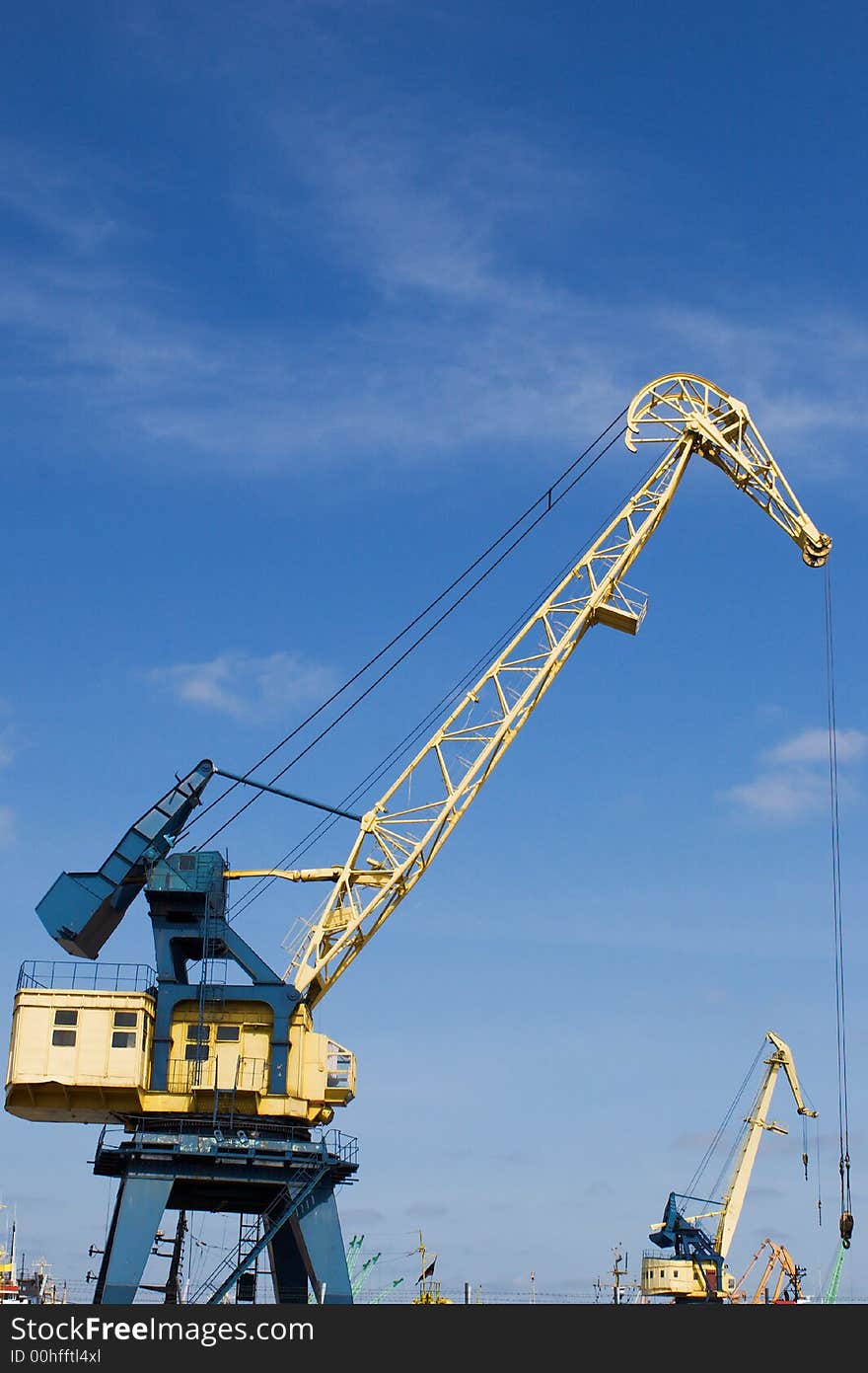 Port crane under blue skies