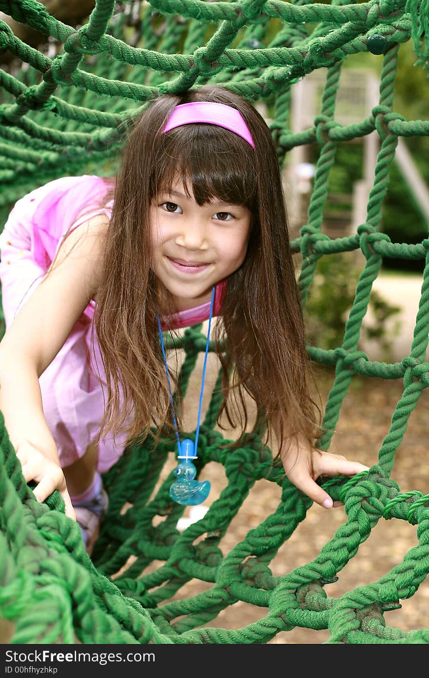 Cute girl in pink play in playground