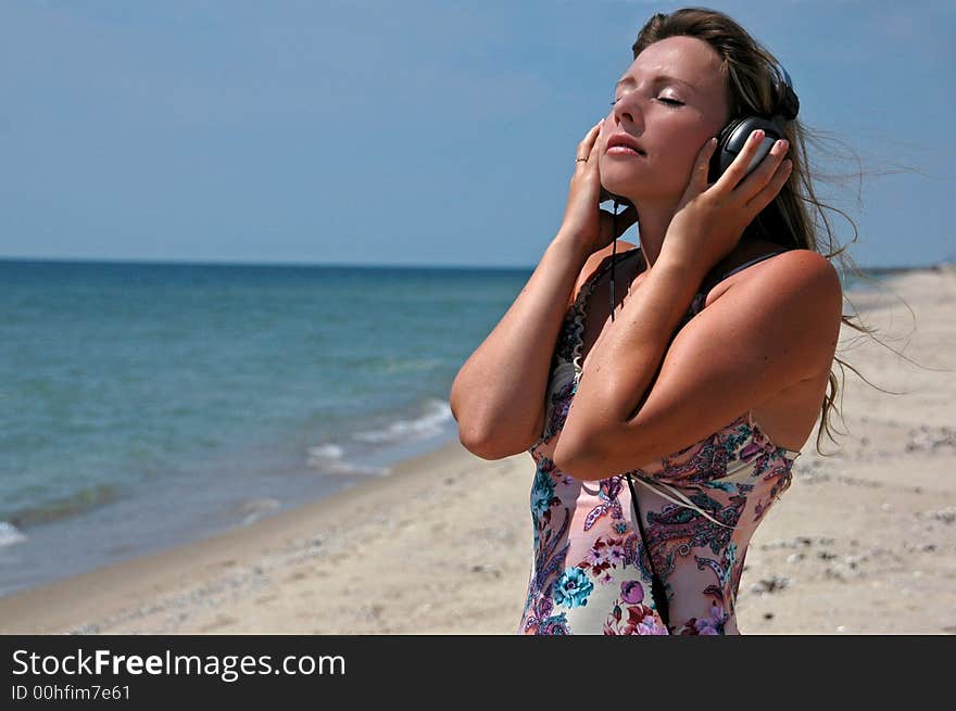 A lovely girl with the headphones listening to music. A lovely girl with the headphones listening to music