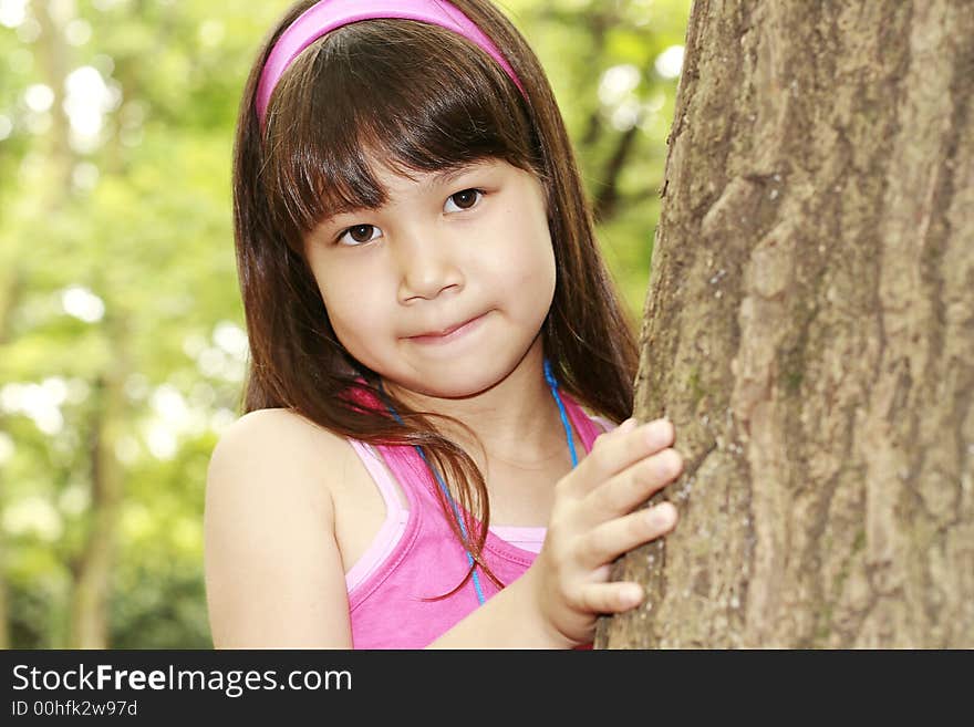 Girl in pink near the tree. Girl in pink near the tree