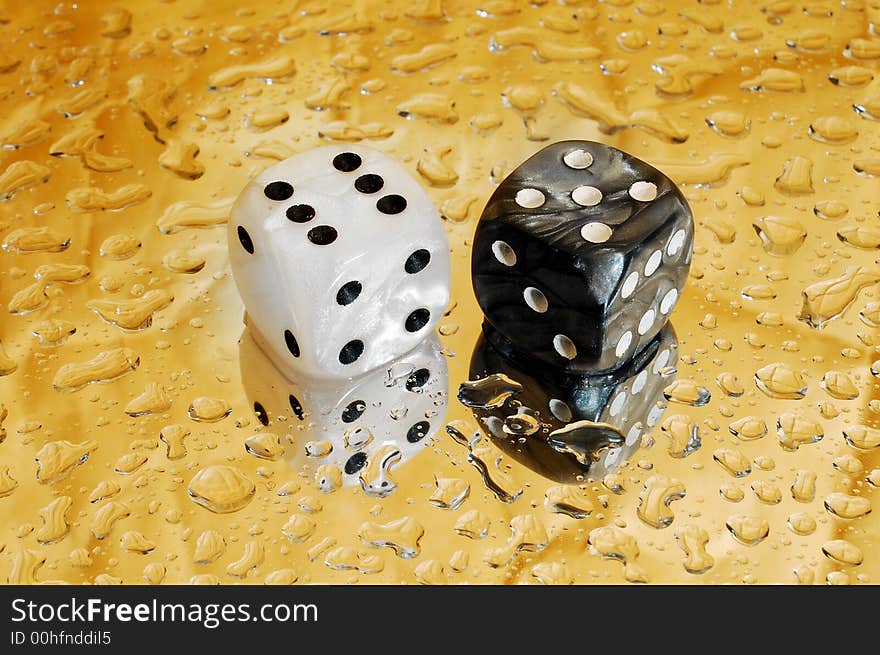 Dice on golden droplets background showing eleven points. Dice on golden droplets background showing eleven points