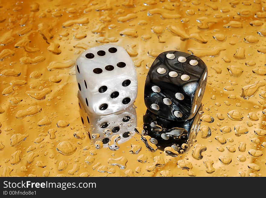 Dice on golden droplets background showing twelve and ten points. Dice on golden droplets background showing twelve and ten points