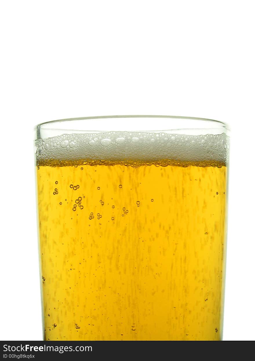 Close-up of glass of lager showing frothy head and bubbles