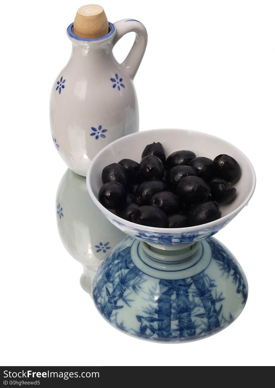 Olives in a ceramic dish with oil jug. Olives in a ceramic dish with oil jug