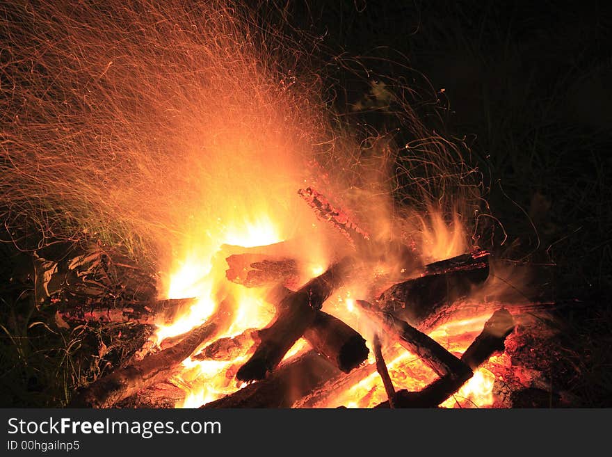 Camp fire at night, flame and spark traces, exposure time 8 sec. Camp fire at night, flame and spark traces, exposure time 8 sec