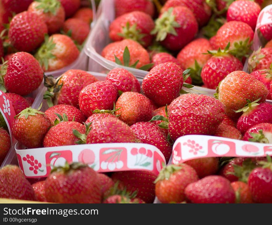 Red strawberries in plastic boxes.