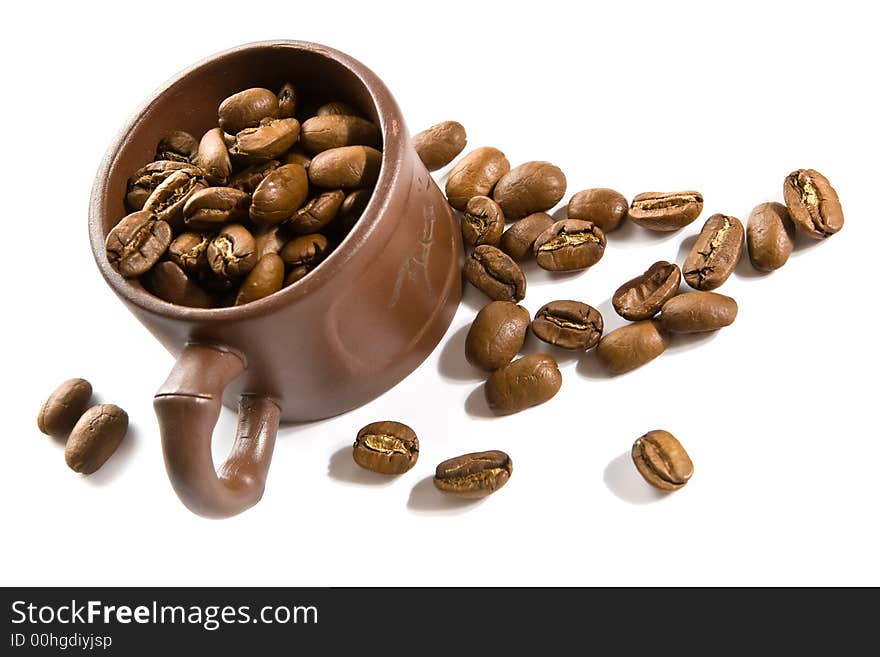 Coffee grains in brown cup