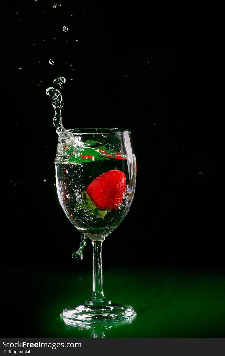 The fruits splash into glass of water. The fruits splash into glass of water