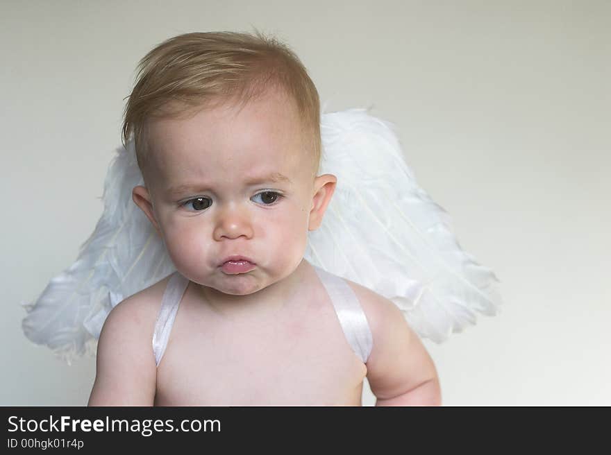 Image of an adorable toddler wearing angel wings. Image of an adorable toddler wearing angel wings